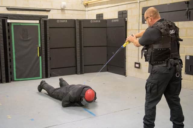 An officer subdues a target in Taser training.