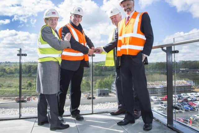 john Kirkland, Matthew Vickerstaff, David Lang and Nick Petford secure the glass balustrade on the Senate Building.