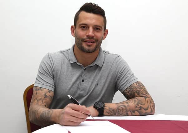 STAYING A COBBLER - skipper and top scorer Marc Richards signs his new Sixfields contract (PICTURE: PETE NORTON)