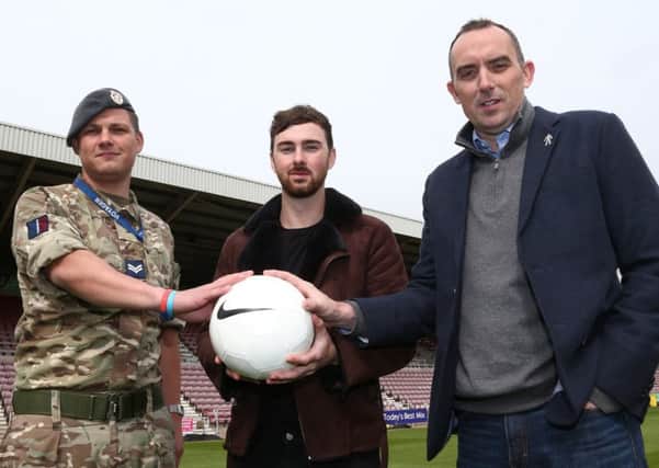 READY FOR KICK-OFF - Birds Of A Feather actor Charlie Quirke (centre) pictured with Cobblers chairman Kelvin Thomas (right) and Stefan Hinton