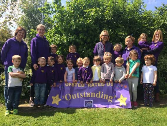 The staff and children of the Brixworth Centre Pre-School with their new banner.
