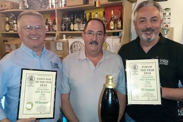 Directors Ray Hunt (left) and John Evans (right) are presented their awards by Ian MacAulay, Chairman of the Northamptonshire branch of CAMRA.