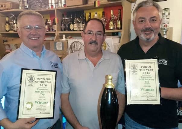 Directors Ray Hunt (left) and John Evans (right) are presented their awards by Ian MacAulay, Chairman of the Northamptonshire branch of CAMRA.