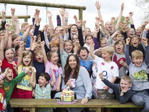 Pupils of East Haddon CoE Primary School crowded around Claire in support of her hard work over the last 25 years.