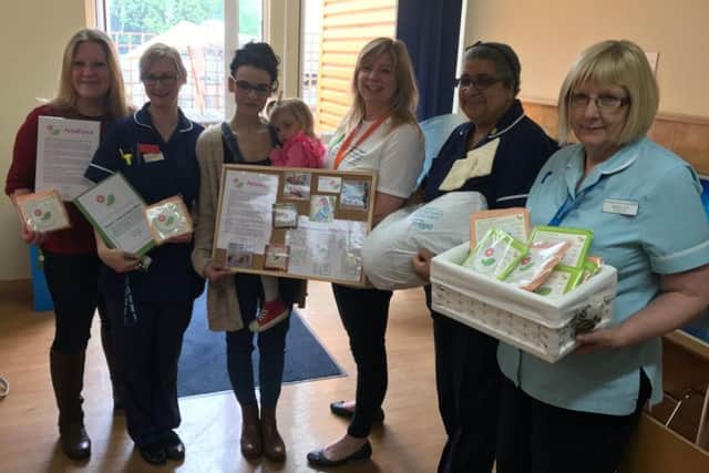 Polly and Gemma present staff at the Gosset SCBU with the PetalPatch blankets.