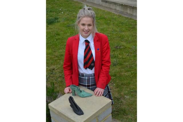 An Upton House School student with her cast bronze shoes.
