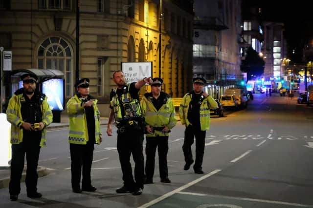 Police arriving at the Manchester Arena on Monday. SWNS.