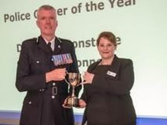Cathy O'Connor receives her award from Chief Constable Simon Edens