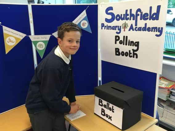 A pupil casts his vote at the Southfields Primary School.