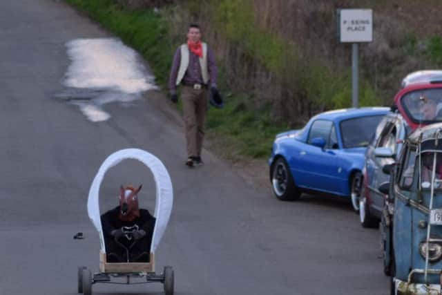 The Muel Fuelers' prototype soapbox races down a private road.