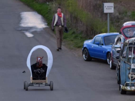 The Muel Fuelers' prototype soapbox races down a private road.