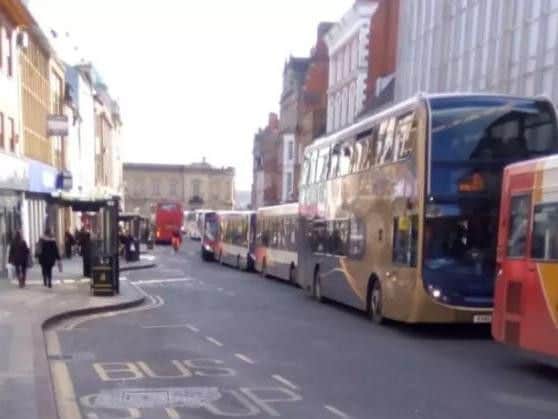 Buses queue along in the Drapery in a traffic jam.
