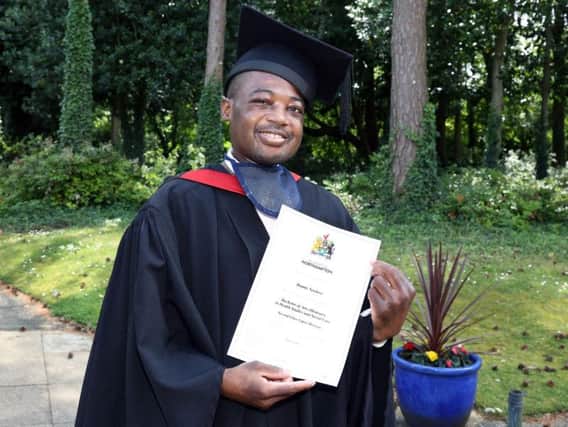 Dennis Newlove, 28, with his 2:1 degree certificate in Health Studies and Social Care.