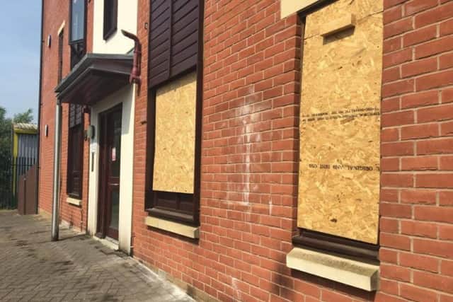 The boarded up windows following the fire