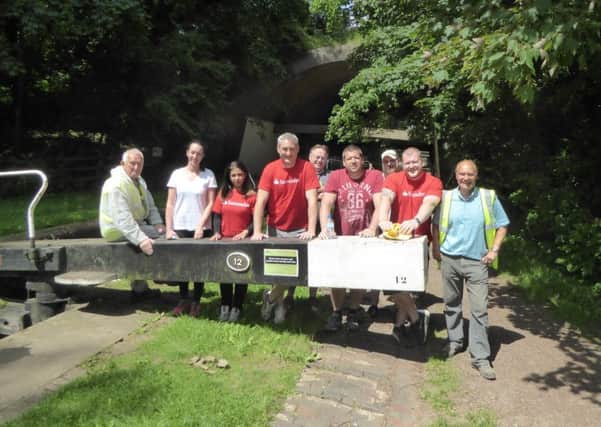 five volunteers from the Inland Waterways Association (IWA) Northampton Branch, seven volunteers from Santander