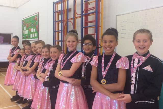 The winners line up with their medals.