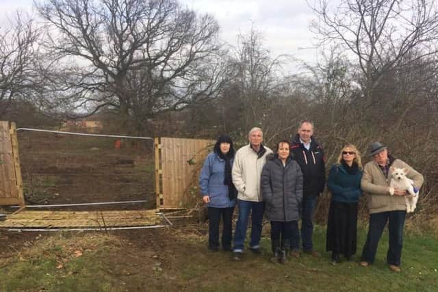 Residents gathered to protest in March when developers cleared an estimated nine acres of trees.