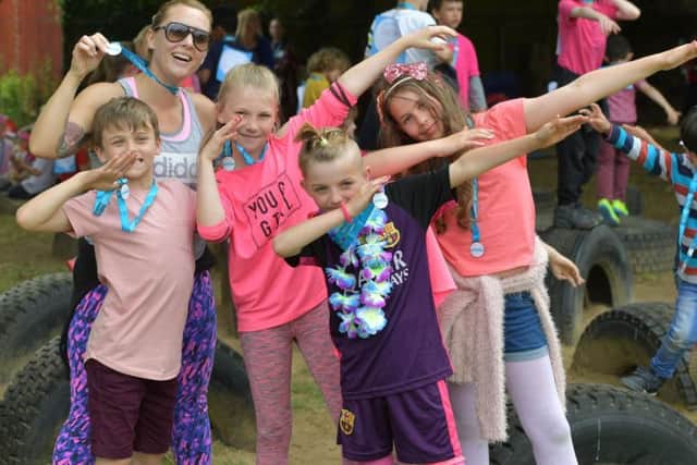 Children got into the spirit of fun while watching on at their friends racing.