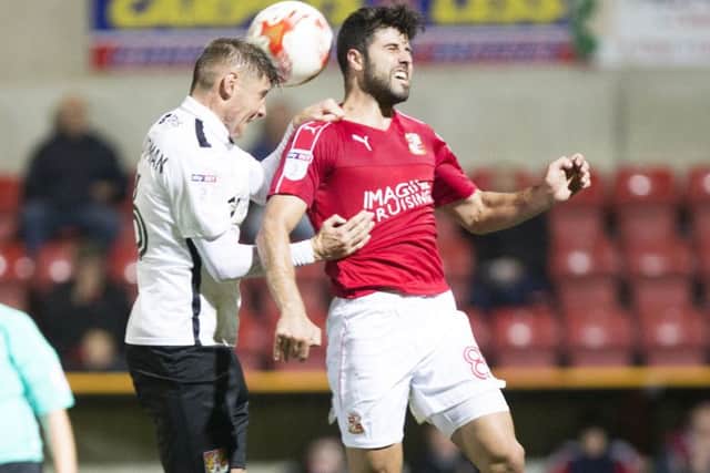 Yaser Kasim battles with Harry Beautyman during Swindon's 3-1 defeat to the Cobblers in September