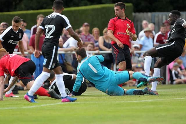 NEW DAWN: Summer signing Leon Barnett strokes home Northampton's opening goal in Saturday's friendly at Fernie Fields. Pictures by Sharon Lucey