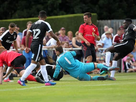NEW DAWN: Summer signing Leon Barnett strokes home Northampton's opening goal in Saturday's friendly at Fernie Fields. Pictures by Sharon Lucey