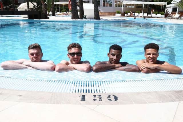 SETTLING IN IN SUNNY SPAIN - Cobblers quartet (from left) James Goff, Joe Iaciafano, Leon Lobjot and Shaun McWilliams relax in the pool at the club's Oliva Nova hotel in Spain. The players arrived on Sunday, and had some free time ahead of Monday's first training session (Picture: Pete Norton)