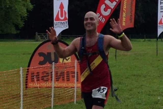 Andy Cottrell at the finishing line of another race on his journey to finishing 100 marathons.