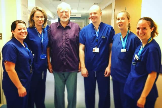 Brian Muddiman, in the plaid shirt, is the first Northampton General Hospital patient to receive the implant.