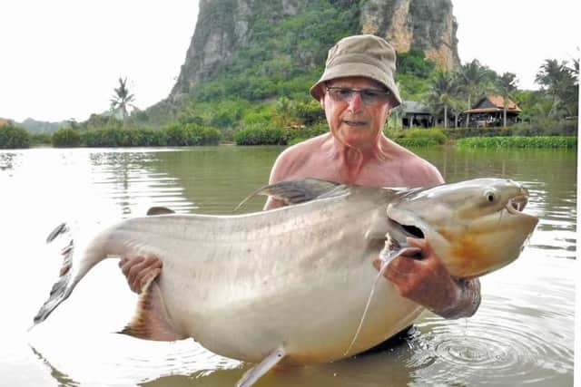 Rod Barley with the 100lb chaophria cat he caught at Jurassic Lake in Thailand
