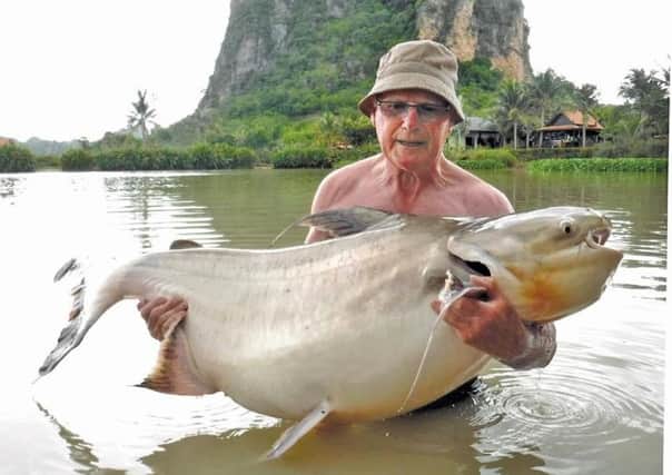 Rod Barley with the 100lb chaophria cat he caught at Jurassic Lake in Thailand