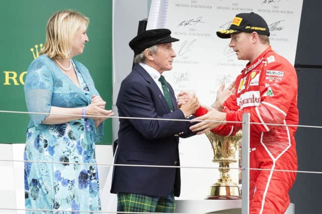 Sir Jackie Stewart on the podium with Kimi Raikonnen