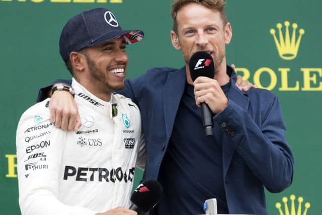 A smiling Lewis Hamilton celebrates his British Grand Prix success with Jenson Button at Silverstone (Pictures: Kirsty Edmonds)