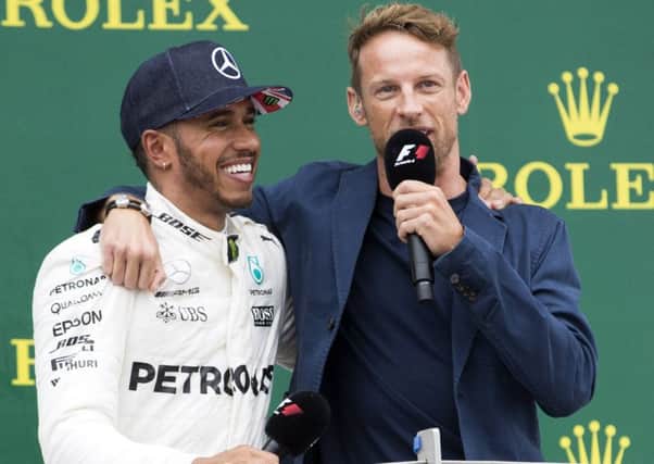 A smiling Lewis Hamilton celebrates his British Grand Prix success with Jenson Button at Silverstone (Pictures: Kirsty Edmonds)
