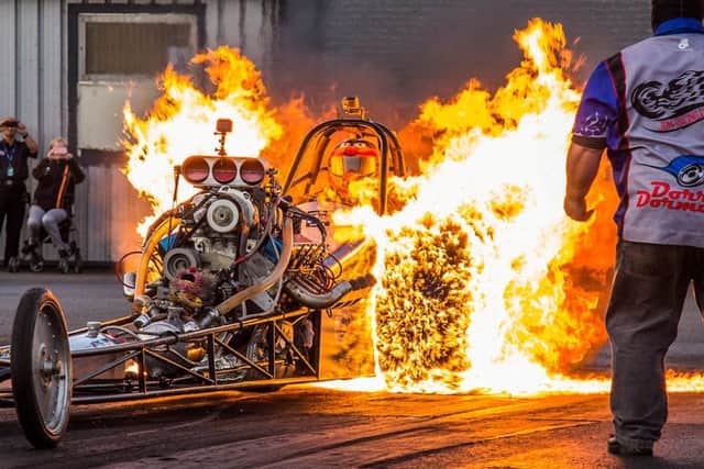 Dramatic image captures a 1,200bhp drag racing car being engulfed in flames as it performs a 'burn out' on the start line. Photo: SWNS