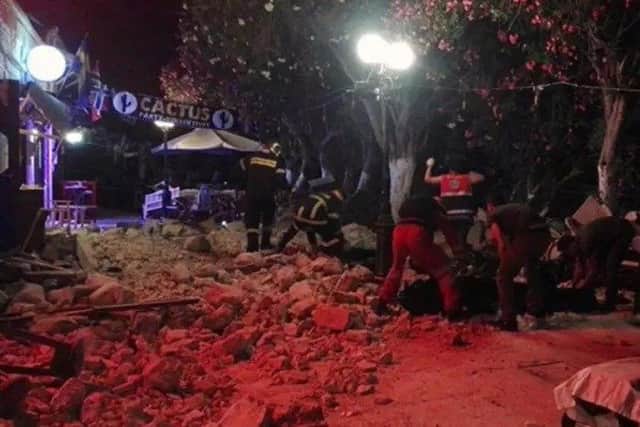 Firefighters and rescuers clear a road after an earthquake on the Greek island of Kos (Kostoday.gr via AP)