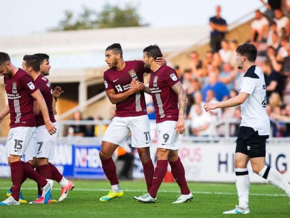 ON TARGET: Marc Richards is congratulated by his team-mates after firing the Cobblers ahead against Derby. Pictures: Kirsty Edmonds