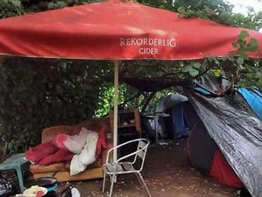 The camp currently has a parasol, chairs and what appears to be a sofa.
