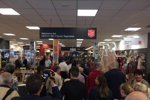 Crowds bustle into the new store at the grand opening today (July 27).