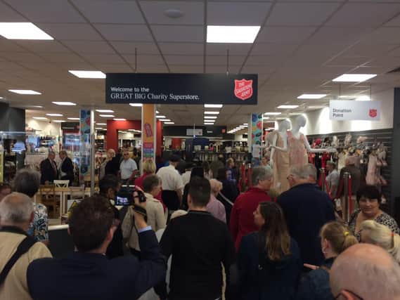 Crowds bustle into the new store at the grand opening today (July 27).