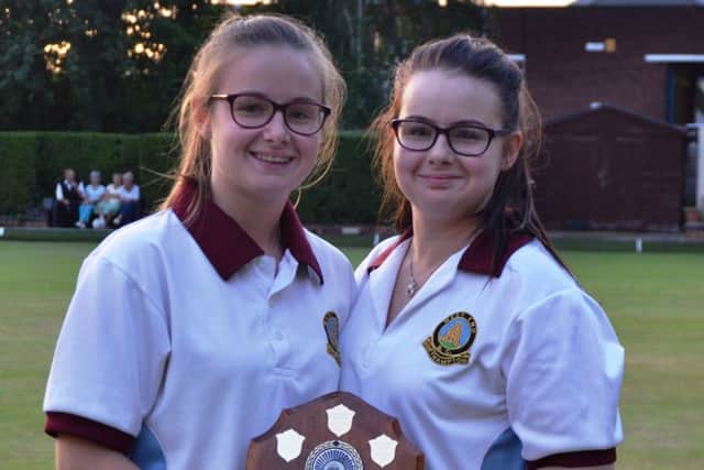 COUNTY CHAMPIONS -  Paige & Abbi Johnson-Young of Northampton West End BC show off the trophy after they won the Ladies Under-25s Pairs county title, seeing off Alice Moore and Louise Haladij