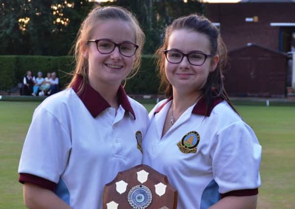 COUNTY CHAMPIONS -  Paige & Abbi Johnson-Young of Northampton West End BC show off the trophy after they won the Ladies Under-25s Pairs county title, seeing off Alice Moore and Louise Haladij
