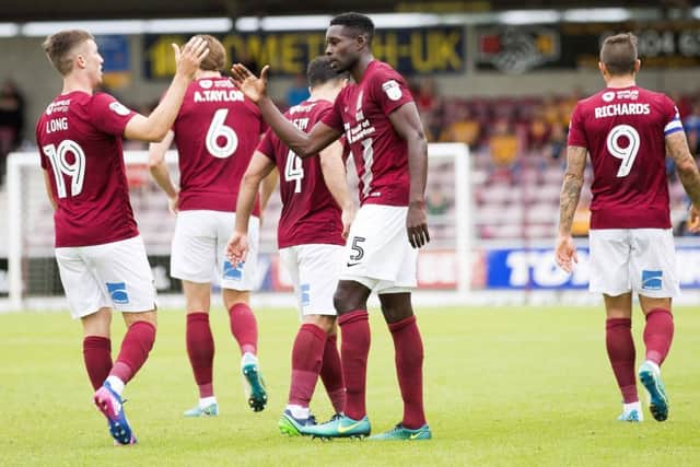 JOB DONE - Chris Long and Leon Barnett celebrate the Cobblers' winning goal at Sixfields on Saturday (Pictures: Kirsty Edmonds)