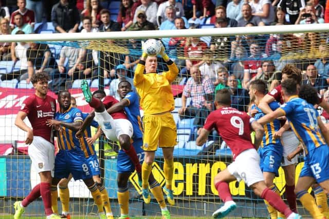 Shrewsbury goalkeeper Dean Henderson claims a cross in the clash with the Cobblers (Pictures: Sharon Lucey)