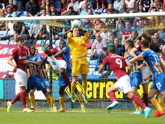 Shrewsbury goalkeeper Dean Henderson claims a cross in the clash with the Cobblers (Pictures: Sharon Lucey)