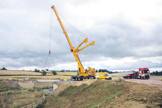 The 60ft crane positions a 30 tonne bridge beam into place