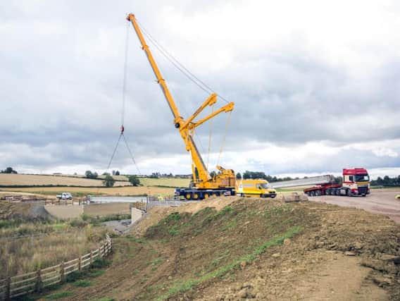 The 60ft crane positions a 30 tonne bridge beam into place