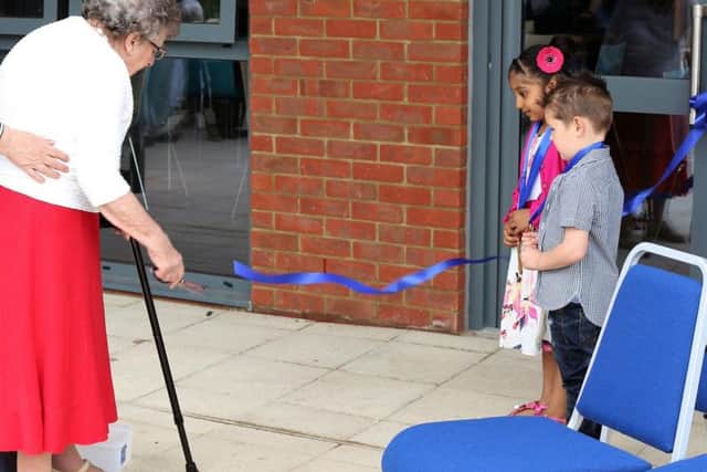 91-year-old Phyllis Wood, who is Moulton's oldest resident, snips the ribbon at the new centre.