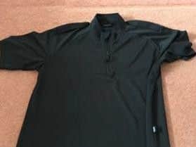 The T-shirt has a small, but significant 'police' logo on it.