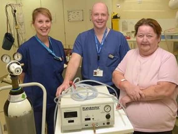 Beverley Blundell (right), the first patient to receive rotablation treatment at Northampton General Hospital, pictured with consultant cardiologist Dr David Sharman and cardiac nurse Hayley Hill.