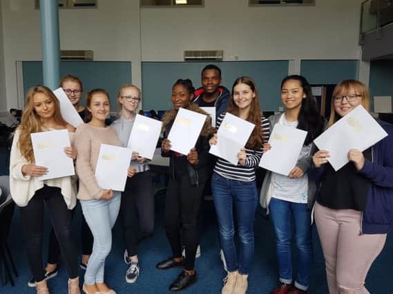 Star pupils at the Duston School with their results.